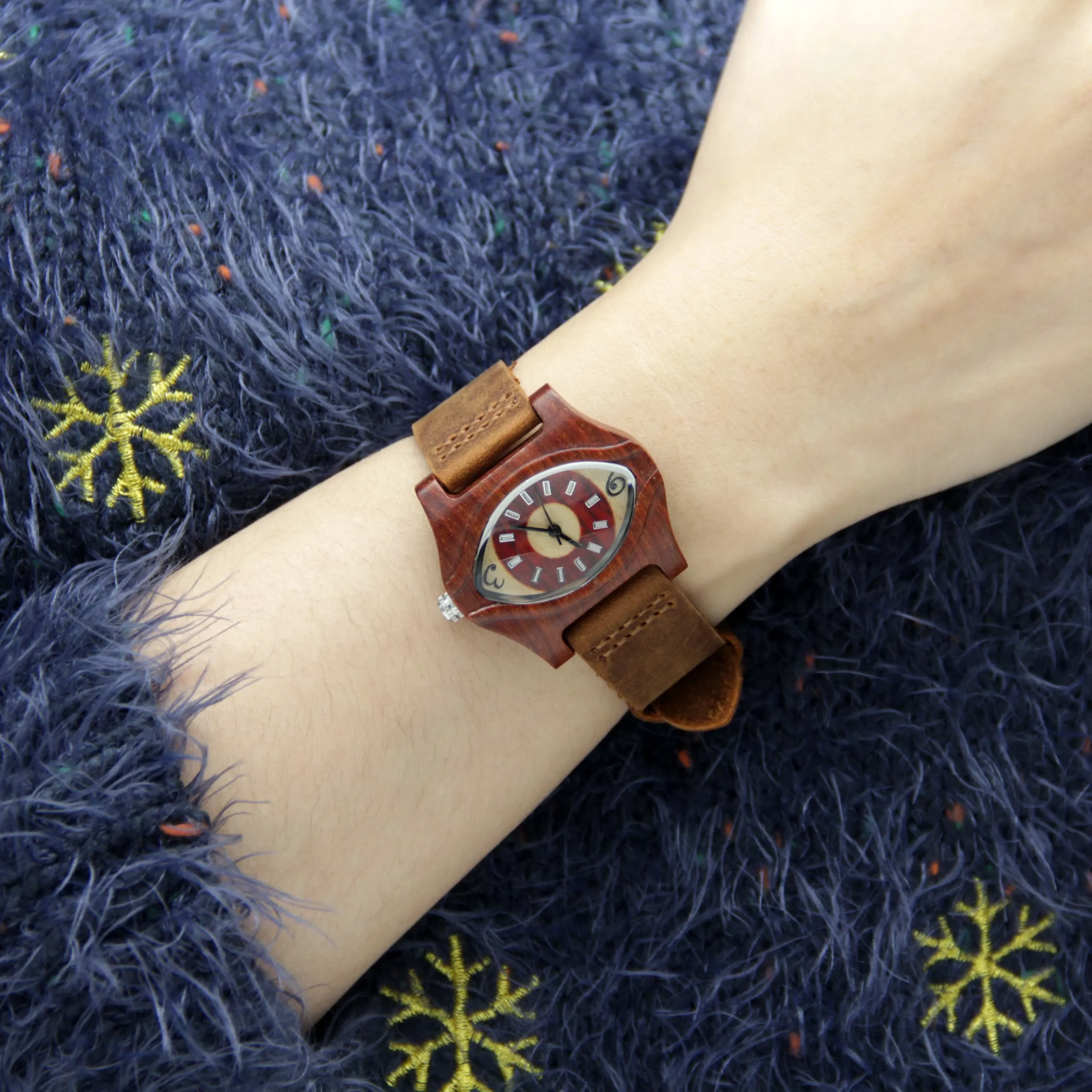 Vintage wooden eye women’s watch with brown strap shown on hand – WatchTrio