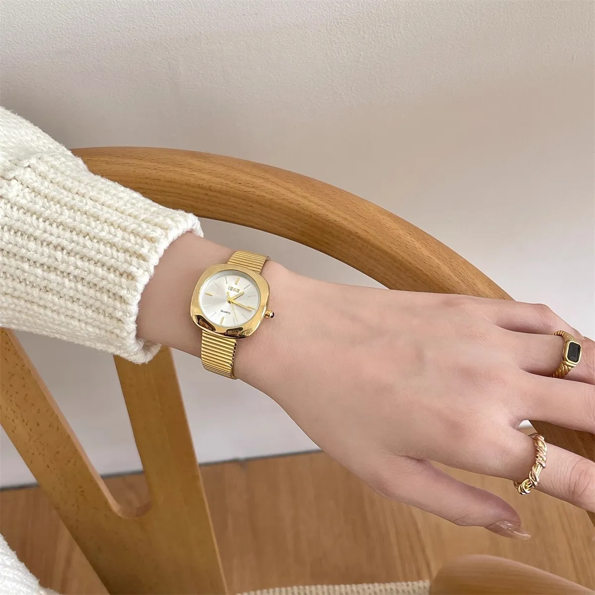 Gold square vintage ladies watch with white dial on wrist