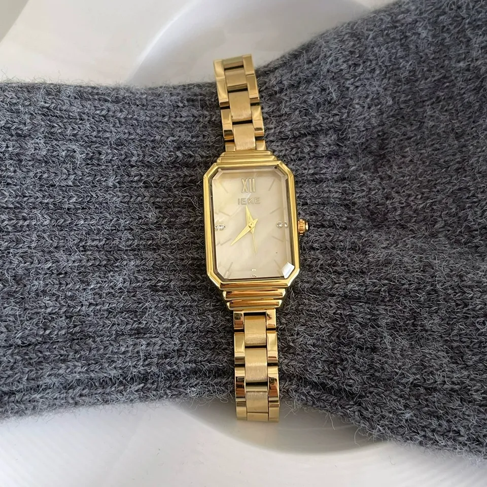 Vintage-style women’s gold rectangular watch with white dial