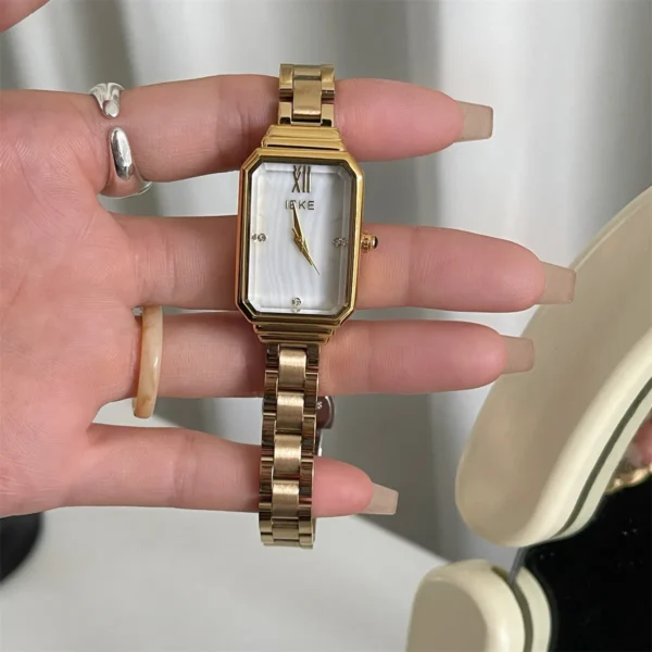 Vintage-style women’s gold rectangular watch with white dial