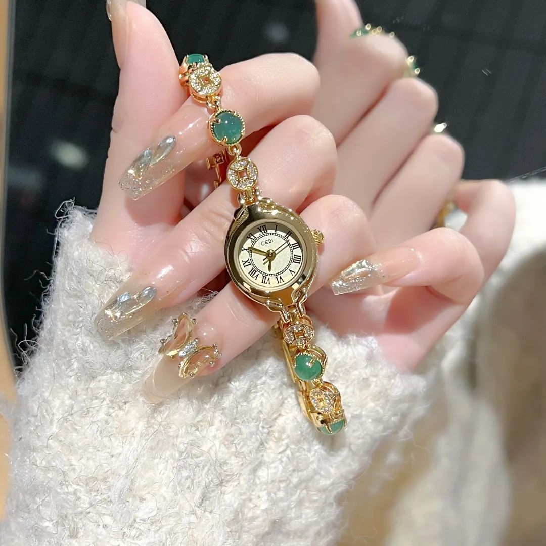 WatchTrio vintage gold women’s bracelet watch with green jade – close-up in hand