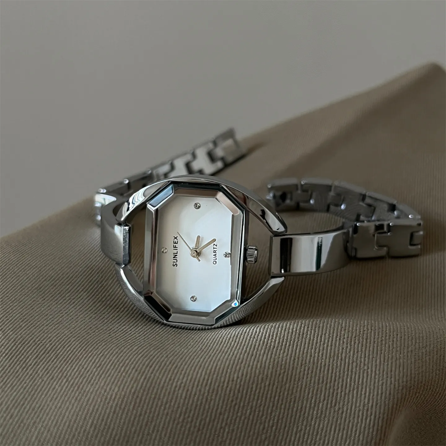 Silver vintage women’s watch with white face and minimalist design