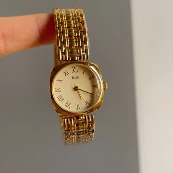 Close-up of vintage square watch for women in gold finish