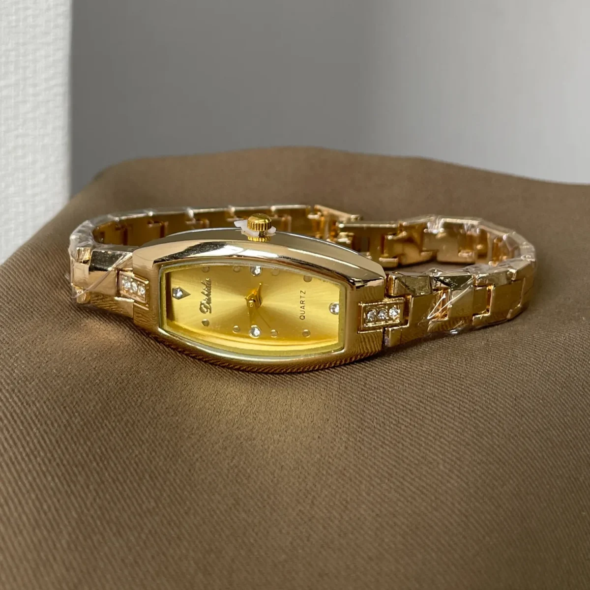 Vintage women’s gold tonneau quartz watch with diamond accents