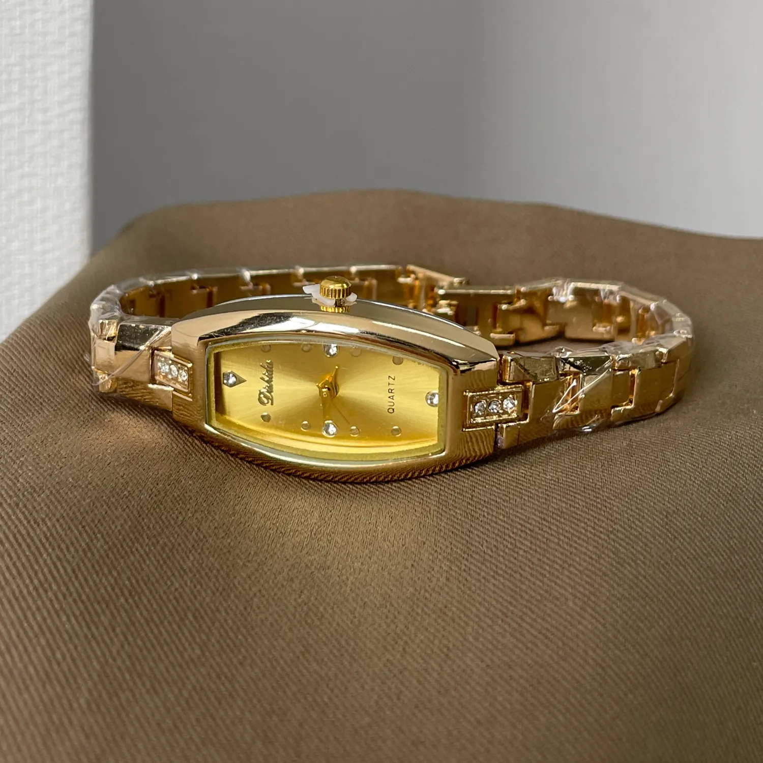 Vintage women’s gold tonneau quartz watch with diamond accents