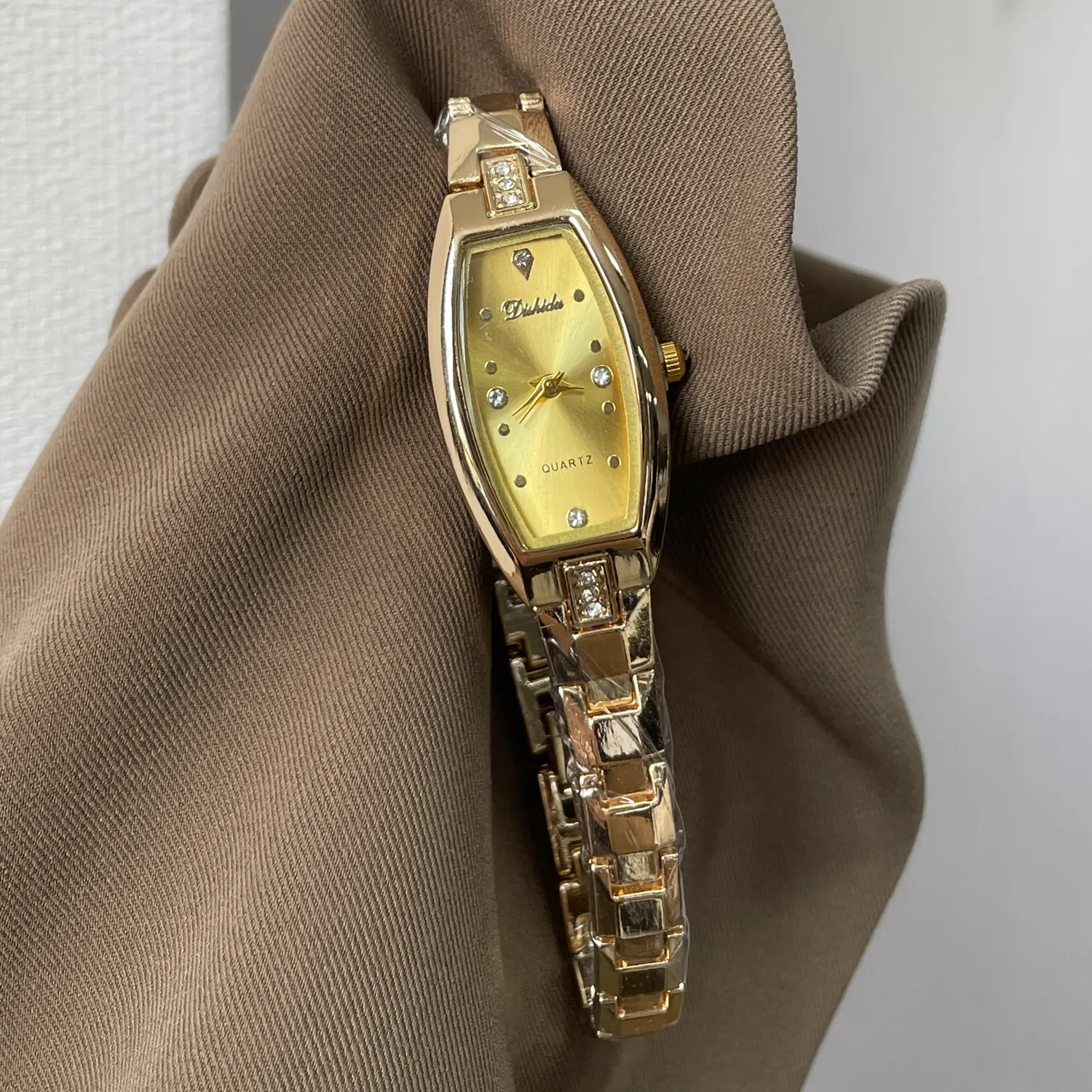 Women’s gold barrel shape quartz watch with diamonds