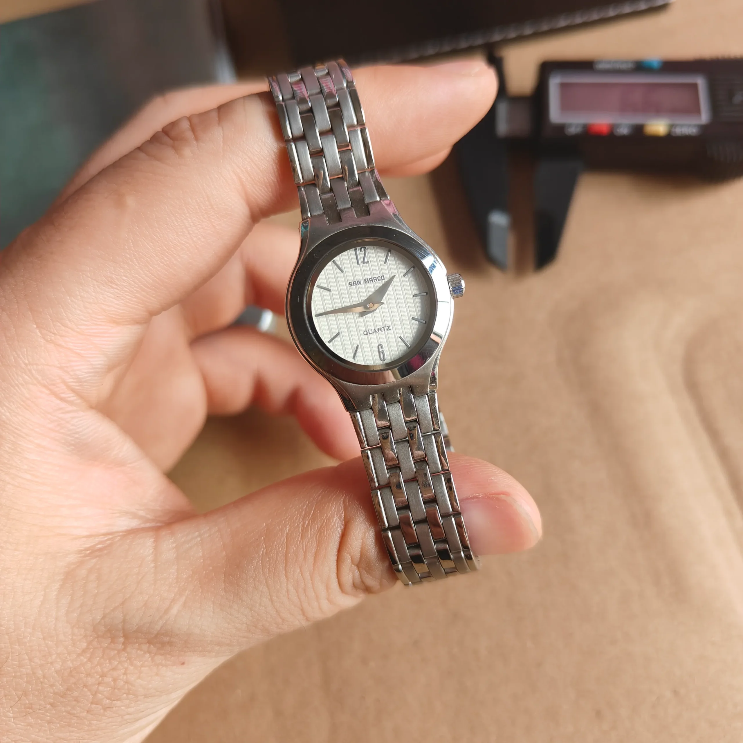 Close-up of vintage women’s silver quartz watch with stainless steel strap