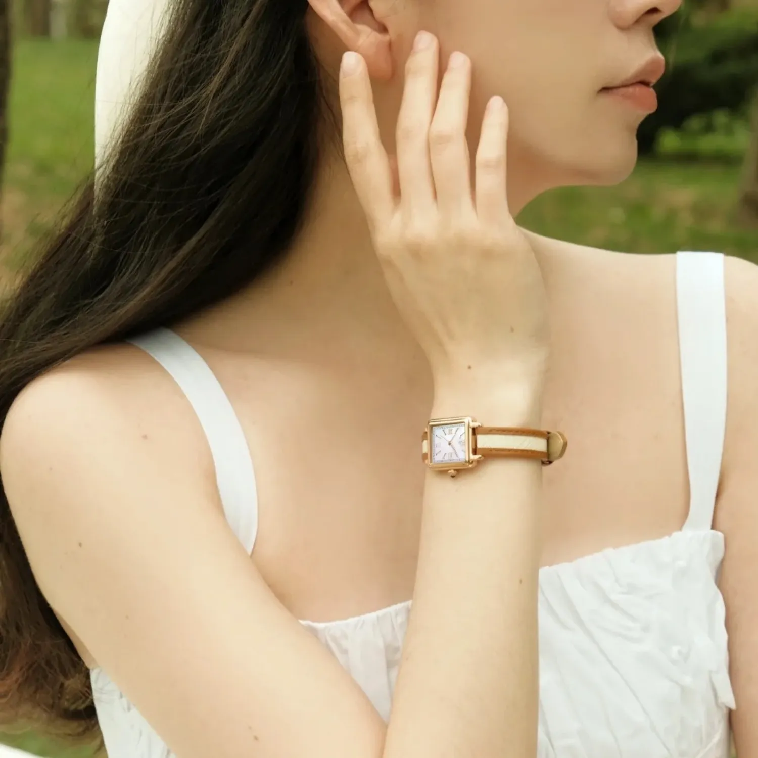 Women’s vintage square quartz watch with leather strap worn by model