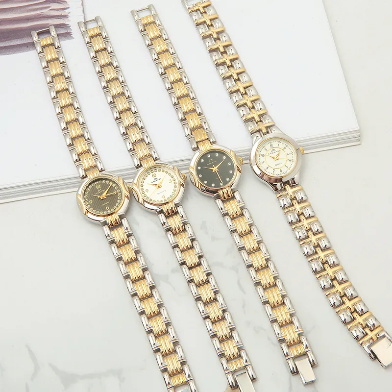 Collection of four vintage women's gold and silver two-tone quartz watches with various dial colors and accents.